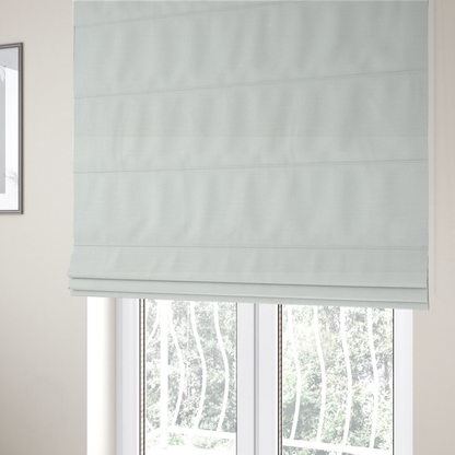 The fabric used to create these Roman blinds is a pale off-white or cream-colored fabric featuring a fine, subtle grid-like texture. The weave consists of horizontal and vertical threads that create a soft, matte finish with a minimalist, clean aesthetic.