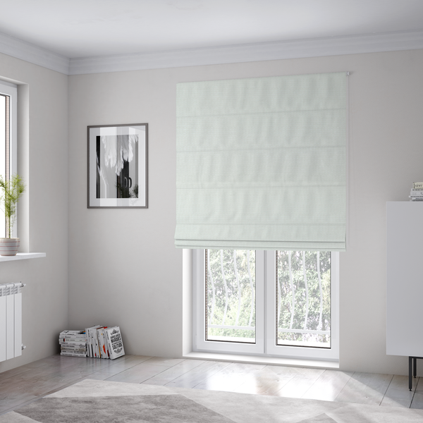 The fabric used to create these Roman blinds is a pale off-white or cream-colored fabric featuring a fine, subtle grid-like texture. The weave consists of horizontal and vertical threads that create a soft, matte finish with a minimalist, clean aesthetic.