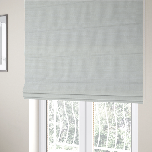 The fabric used to create these Roman blinds is a off-white fabric with a prominent horizontal ribbed texture. The weave features thicker, raised cream threads that create a subtle striped effect on a matte, textured surface, ideal for modern interior design.