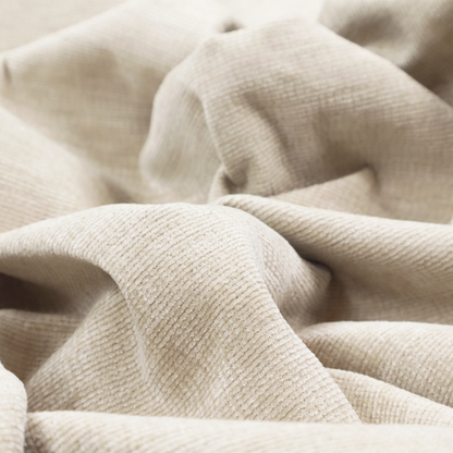 A warm beige or oatmeal-coloured fabric featuring a dense, horizontal corded texture. The weave has a soft, chenille-like appearance with closely packed raised lines, creating a cosy and high-tactile surface.