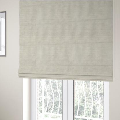 The fabric used to create these Roman blinds is a warm beige or oatmeal-coloured fabric featuring a dense, horizontal corded texture. The weave has a soft, chenille-like appearance with closely packed raised lines, creating a cosy and high-tactile surface.
