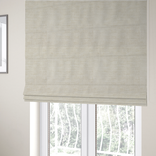 The fabric used to create these Roman blinds is a warm beige or oatmeal-coloured fabric featuring a dense, horizontal corded texture. The weave has a soft, chenille-like appearance with closely packed raised lines, creating a cosy and high-tactile surface.