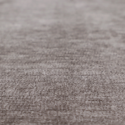 A taupe or ash brown fabric with a dense, horizontal ribbed texture. The material features a soft, velvety pile that creates subtle light-catching highlights and shadows across the linear weave.
