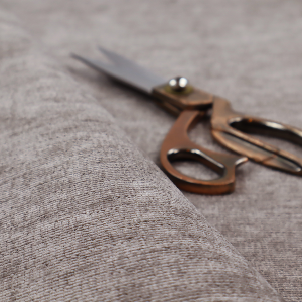 A taupe or ash brown fabric with a dense, horizontal ribbed texture. The material features a soft, velvety pile that creates subtle light-catching highlights and shadows across the linear weave.