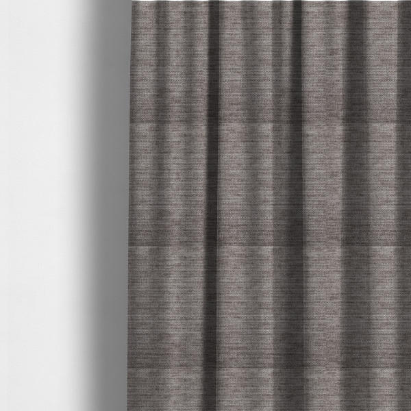 The fabric used to create these made-to-measure curtains is a taupe or ash brown fabric with a dense, horizontal ribbed texture. The material features a soft, velvety pile that creates subtle light-catching highlights and shadows across the linear weave.