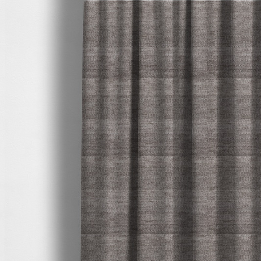 The fabric used to create these made-to-measure curtains is a taupe or ash brown fabric with a dense, horizontal ribbed texture. The material features a soft, velvety pile that creates subtle light-catching highlights and shadows across the linear weave.