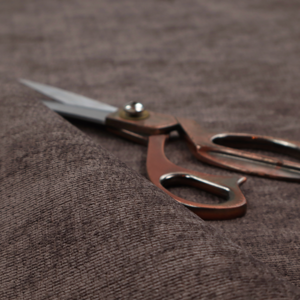 A deep charcoal or cocoa-brown fabric with a heavy horizontal corded texture. The dense, linear weave creates a multi-tonal effect with subtle shadows, offering a sophisticated and cosy tactile appearance.