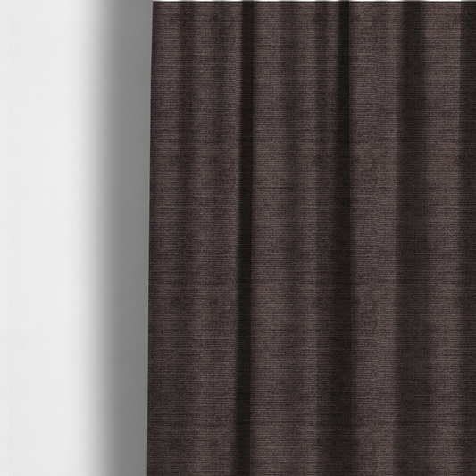The fabric used to create these made-to-measure curtains is a deep charcoal or cocoa-brown fabric with a heavy horizontal corded texture. The dense, linear weave creates a multi-tonal effect with subtle shadows, offering a sophisticated and cosy tactile appearance.