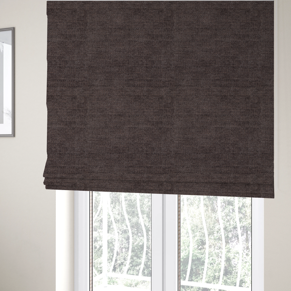 The fabric used to create these Roman blinds is a deep charcoal or cocoa-brown fabric with a heavy horizontal corded texture. The dense, linear weave creates a multi-tonal effect with subtle shadows, offering a sophisticated and cosy tactile appearance.