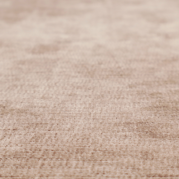 A warm rosy-taupe or dusty mauve fabric with a soft, chenille-like horizontal rib. The texture is plush and slightly irregular, creating a comfortable, lived-in look with subtle variations in colour and light.