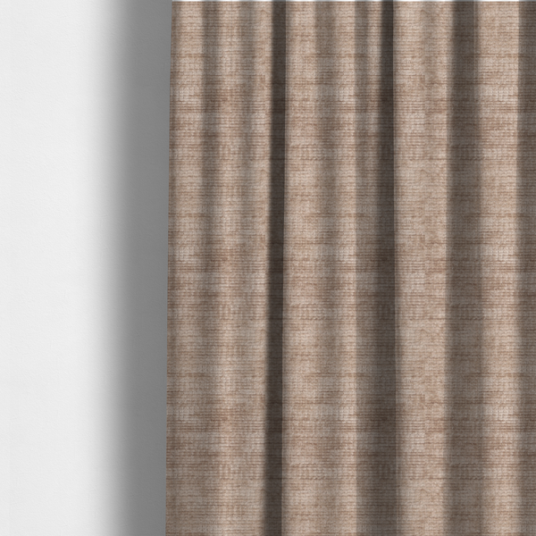 The fabric used to create these made-to-measure curtains is a warm rosy-taupe or dusty mauve fabric with a soft, chenille-like horizontal rib. The texture is plush and slightly irregular, creating a comfortable, lived-in look with subtle variations in colour and light.