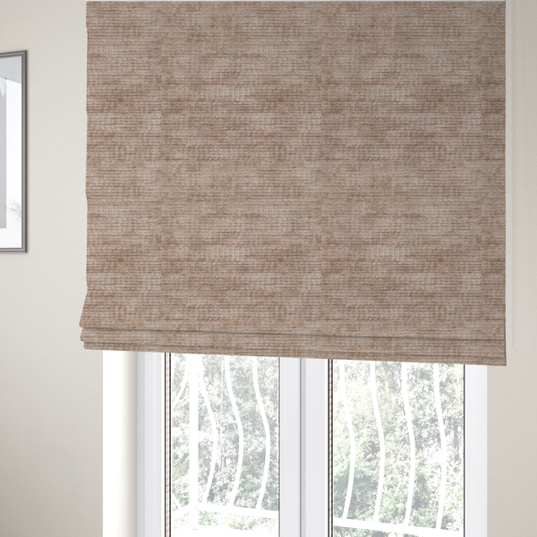 The fabric used to create these Roman blinds is a warm rosy-taupe or dusty mauve fabric with a soft, chenille-like horizontal rib. The texture is plush and slightly irregular, creating a comfortable, lived-in look with subtle variations in colour and light.