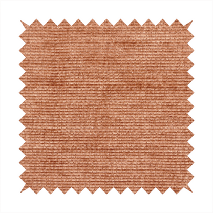 A burnt orange fabric with a dense, horizontal corded texture. The weave has a soft, plush pile similar to corduroy, creating a rich tonal depth with warm highlights and subtle shadows across the linear pattern.