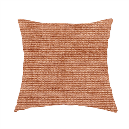 The fabric used to create these handmade cushions is a burnt orange fabric with a dense, horizontal corded texture. The weave has a soft, plush pile similar to corduroy, creating a rich tonal depth with warm highlights and subtle shadows across the linear pattern.
