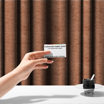 The fabric used to create these made-to-measure curtains is a burnt orange fabric with a dense, horizontal corded texture. The weave has a soft, plush pile similar to corduroy, creating a rich tonal depth with warm highlights and subtle shadows across the linear pattern.