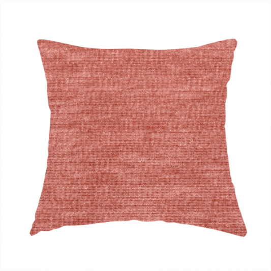 The fabric used to create these handmade cushions is a dusty rose or salmon-pink fabric with a soft, multi-directional texture. While it maintains a subtle horizontal grain, the weave is more flecked and feathered than previous styles, creating a plush, velvet-like surface with organic light-catching highlights.
