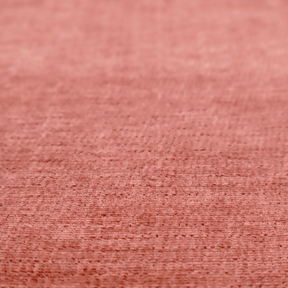 A dusty rose or salmon-pink fabric with a soft, multi-directional texture. While it maintains a subtle horizontal grain, the weave is more flecked and feathered than previous styles, creating a plush, velvet-like surface with organic light-catching highlights.