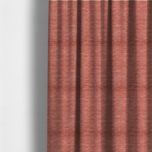 The fabric used to create these made-to-measure curtains is a dusty rose or salmon-pink fabric with a soft, multi-directional texture. While it maintains a subtle horizontal grain, the weave is more flecked and feathered than previous styles, creating a plush, velvet-like surface with organic light-catching highlights.