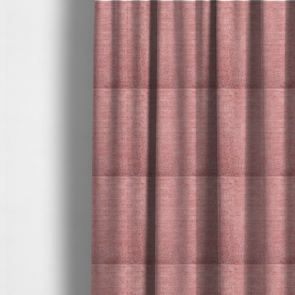 The fabric used to create these made-to-measure curtains is a vibrant mauve-pink or raspberry-toned fabric featuring a dense, horizontal corded texture. The soft, plush weave creates a uniform linear pattern with a subtle velvety sheen that catches the light along each ridge.