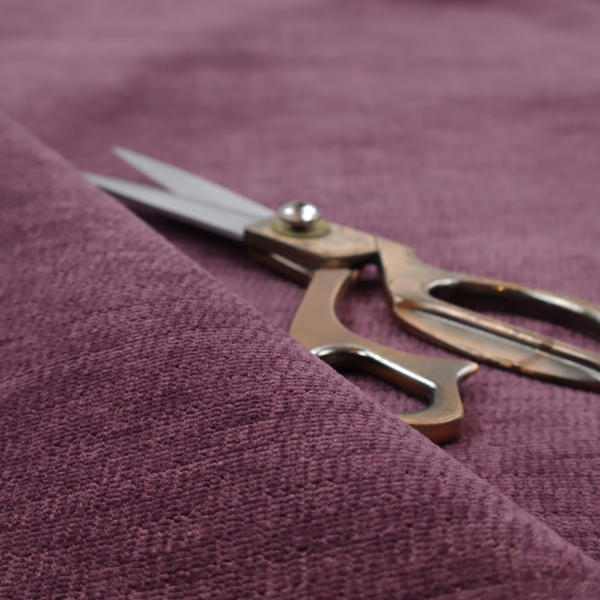 A deep plum or dark berry purple fabric with a rich, textured weave. It features a subtle horizontal grain combined with a soft, mottled pile that creates depth through varying shades of purple and wine, resulting in a plush and sophisticated finish.