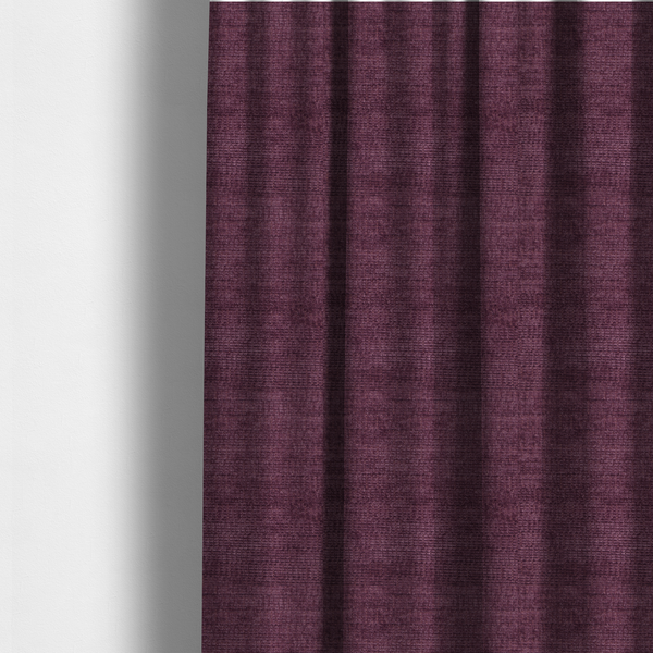 The fabric used to create these made-to-measure curtains is a deep plum or dark berry purple fabric with a rich, textured weave. It features a subtle horizontal grain combined with a soft, mottled pile that creates depth through varying shades of purple and wine, resulting in a plush and sophisticated finish.