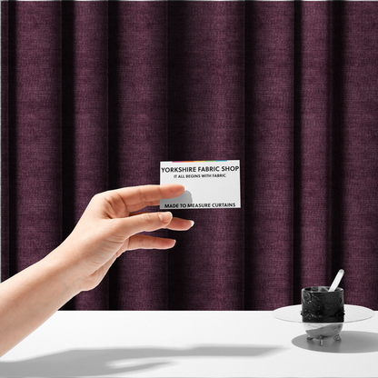 The fabric used to create these made-to-measure curtains is a deep plum or dark berry purple fabric with a rich, textured weave. It features a subtle horizontal grain combined with a soft, mottled pile that creates depth through varying shades of purple and wine, resulting in a plush and sophisticated finish.