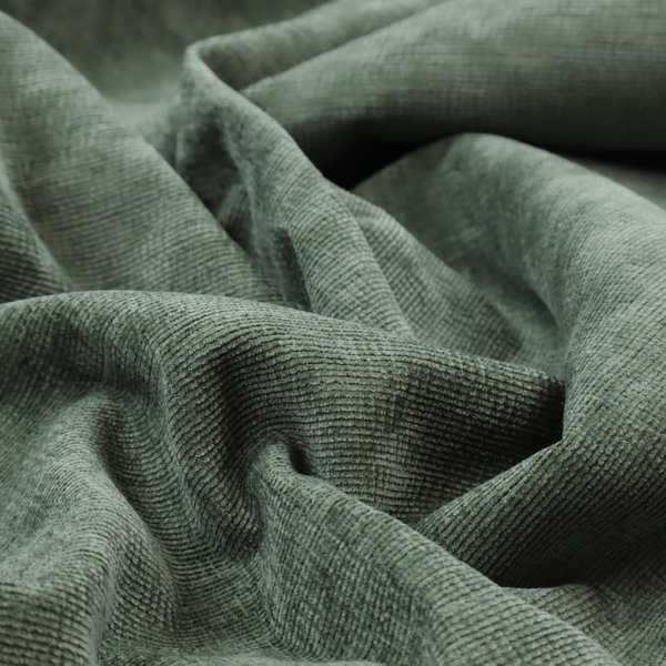 A forest green fabric with a dense horizontal ribbed texture. The weave features a soft, velvety pile that creates a subtle play of light and shadow across the linear ridges, giving the material a rich, organic feel.