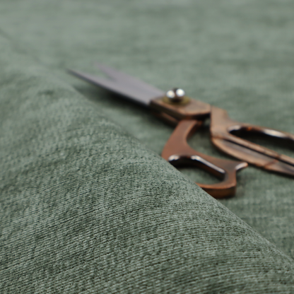 A forest green fabric with a dense horizontal ribbed texture. The weave features a soft, velvety pile that creates a subtle play of light and shadow across the linear ridges, giving the material a rich, organic feel.