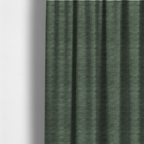 The fabric used to create these made-to-measure curtains is a forest green fabric with a dense horizontal ribbed texture. The weave features a soft, velvety pile that creates a subtle play of light and shadow across the linear ridges, giving the material a rich, organic feel.