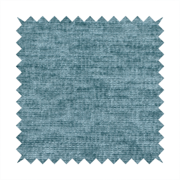a teal or dusty blue fabric with a soft, weathered texture. The weave features a subtle horizontal grain with a plush, multi-tonal pile that blends shades of slate and ocean blue for a rich, tactile appearance.