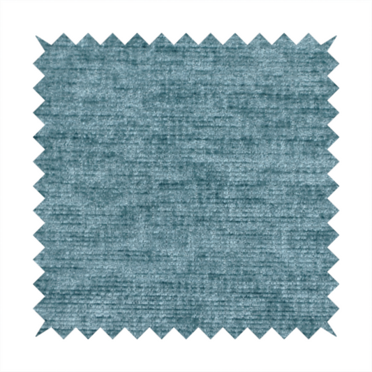 a teal or dusty blue fabric with a soft, weathered texture. The weave features a subtle horizontal grain with a plush, multi-tonal pile that blends shades of slate and ocean blue for a rich, tactile appearance.