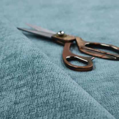 a teal or dusty blue fabric with a soft, weathered texture. The weave features a subtle horizontal grain with a plush, multi-tonal pile that blends shades of slate and ocean blue for a rich, tactile appearance.