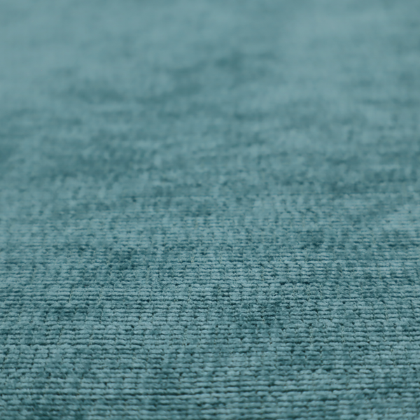 A deep peacock blue fabric with a structured horizontal corded texture. The plush, velvety ridges create a dense linear pattern, offering a sophisticated play of light and shadow with a soft, durable finish.