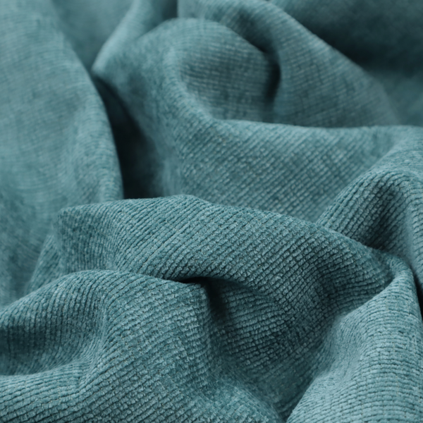 A deep peacock blue fabric with a structured horizontal corded texture. The plush, velvety ridges create a dense linear pattern, offering a sophisticated play of light and shadow with a soft, durable finish.