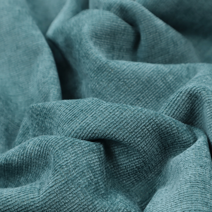 A deep peacock blue fabric with a structured horizontal corded texture. The plush, velvety ridges create a dense linear pattern, offering a sophisticated play of light and shadow with a soft, durable finish.