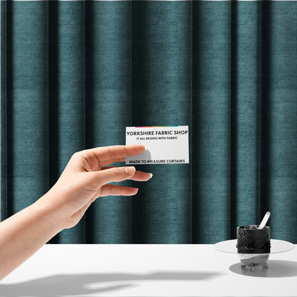 The fabric used to create these made-to-measure curtains is a deep peacock blue fabric with a structured horizontal corded texture. The plush, velvety ridges create a dense linear pattern, offering a sophisticated play of light and shadow with a soft, durable finish.