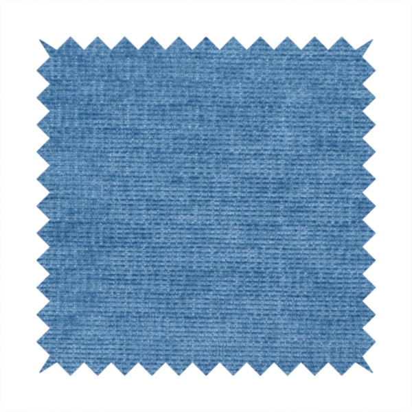 A vibrant mid-blue or cornflower blue fabric featuring a dense horizontal corded texture. The weave has a soft, plush finish with a subtle velvety sheen that creates light-catching highlights across the uniform linear ridges.