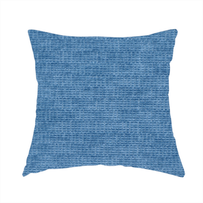 The fabric used to create these handmade cushions is a vibrant mid-blue or cornflower blue fabric featuring a dense horizontal corded texture. The weave has a soft, plush finish with a subtle velvety sheen that creates light-catching highlights across the uniform linear ridges.