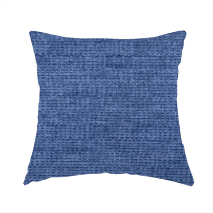 The fabric used to create these handmade cushions is a deep royal blue or indigo fabric with a dense horizontal ribbed texture. The weave features a soft, plush pile that creates a multi-tonal effect with rich shadows and mid-tone blue highlights across the linear ridges.