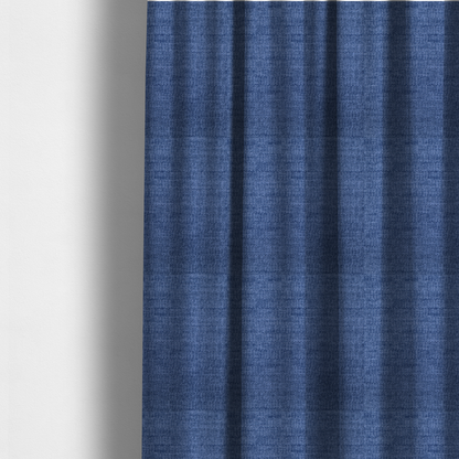 The fabric used to create these made-to-measure curtains is a deep royal blue or indigo fabric with a dense horizontal ribbed texture. The weave features a soft, plush pile that creates a multi-tonal effect with rich shadows and mid-tone blue highlights across the linear ridges.