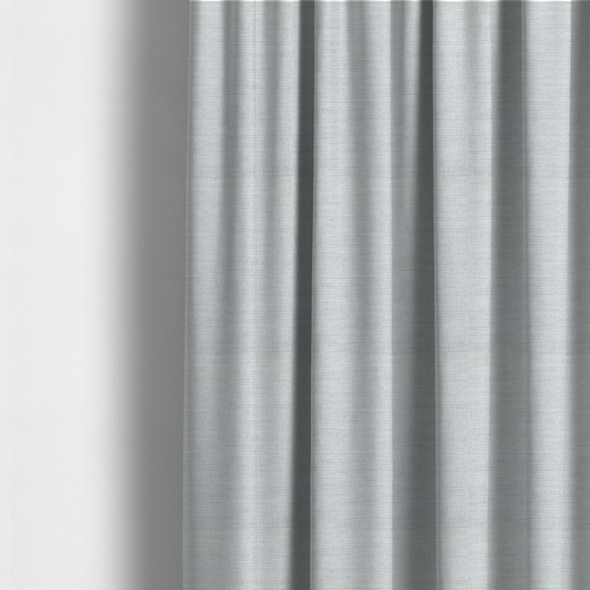 The fabric used to create these made-to-measure curtains is a cool, silver-white fabric with a soft, uniform horizontal ribbed texture. The material features a plush, chenille-like pile that provides a subtle, velvety sheen, catching the light across the fine linear ridges for a clean and modern look.