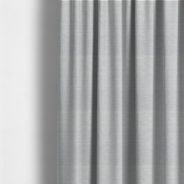 The fabric used to create these made-to-measure curtains is a light grey fabric with a soft, uniform horizontal ribbed texture. The weave has a plush, velvety pile that creates subtle shadows and highlights across the linear ridges, providing a clean, modern aesthetic with a tactile feel.