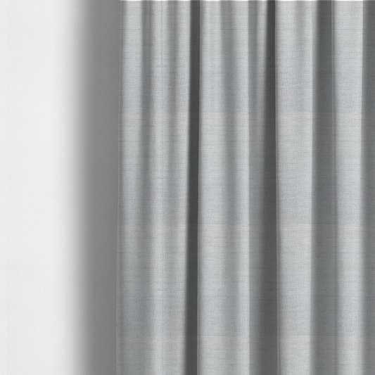 The fabric used to create these made-to-measure curtains is a light grey fabric with a soft, uniform horizontal ribbed texture. The weave has a plush, velvety pile that creates subtle shadows and highlights across the linear ridges, providing a clean, modern aesthetic with a tactile feel.