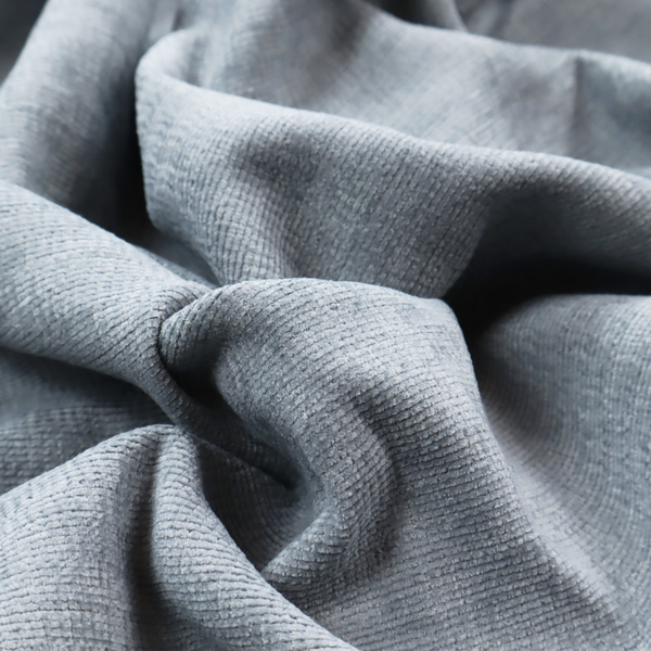 A slate grey fabric with a dense horizontal ribbed texture. The material features a plush, velvety pile with subtle mottled highlights, creating a rich, tactile surface that offers both depth and a modern, clean aesthetic.