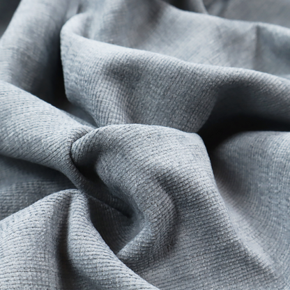 A slate grey fabric with a dense horizontal ribbed texture. The material features a plush, velvety pile with subtle mottled highlights, creating a rich, tactile surface that offers both depth and a modern, clean aesthetic.