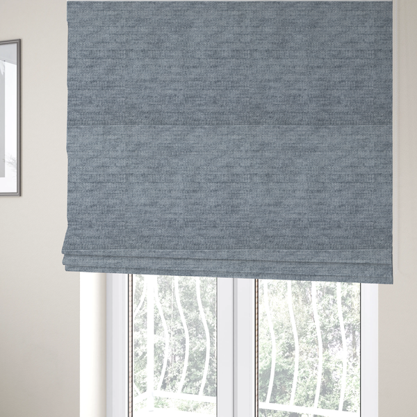 The fabric used to create these Roman blinds is a slate grey fabric with a dense horizontal ribbed texture. The material features a plush, velvety pile with subtle mottled highlights, creating a rich, tactile surface that offers both depth and a modern, clean aesthetic.