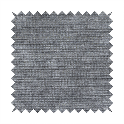 A dark charcoal grey fabric with a dense horizontal ribbed texture. The weave features a soft, plush pile with subtle weathered variations, creating a multi-tonal smoky effect that adds depth and a sophisticated matte finish.