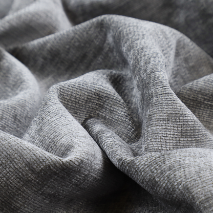 A dark charcoal grey fabric with a dense horizontal ribbed texture. The weave features a soft, plush pile with subtle weathered variations, creating a multi-tonal smoky effect that adds depth and a sophisticated matte finish.