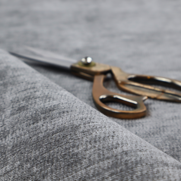 A dark charcoal grey fabric with a dense horizontal ribbed texture. The weave features a soft, plush pile with subtle weathered variations, creating a multi-tonal smoky effect that adds depth and a sophisticated matte finish.