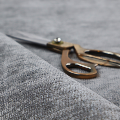 A dark charcoal grey fabric with a dense horizontal ribbed texture. The weave features a soft, plush pile with subtle weathered variations, creating a multi-tonal smoky effect that adds depth and a sophisticated matte finish.